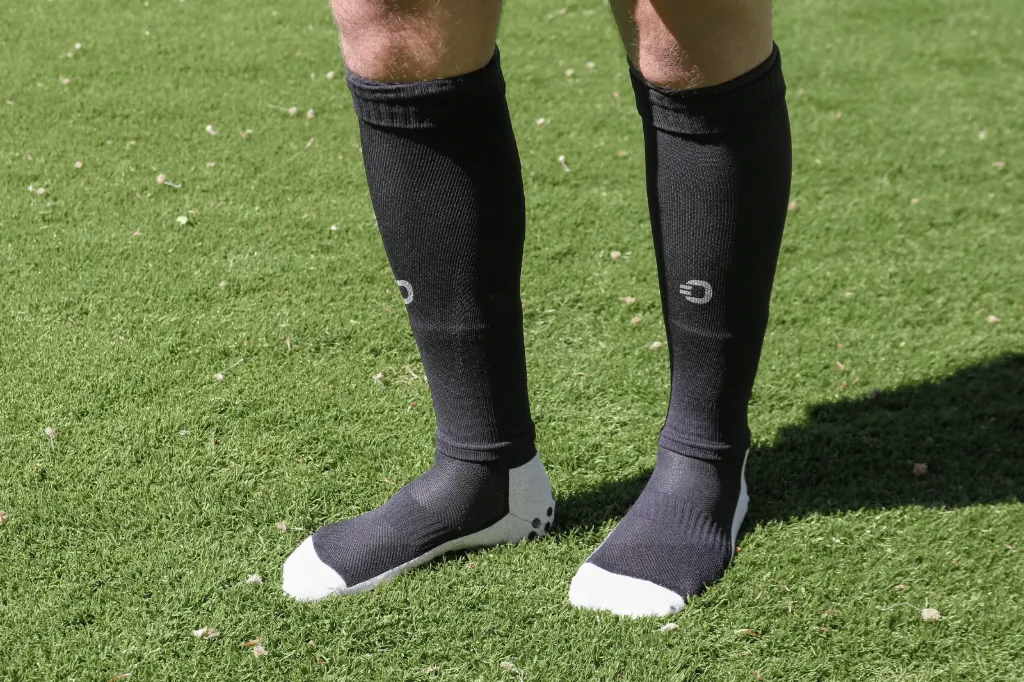 Vorderansicht der schwarzen Cut Sleeves mit separat getragenen Socken.